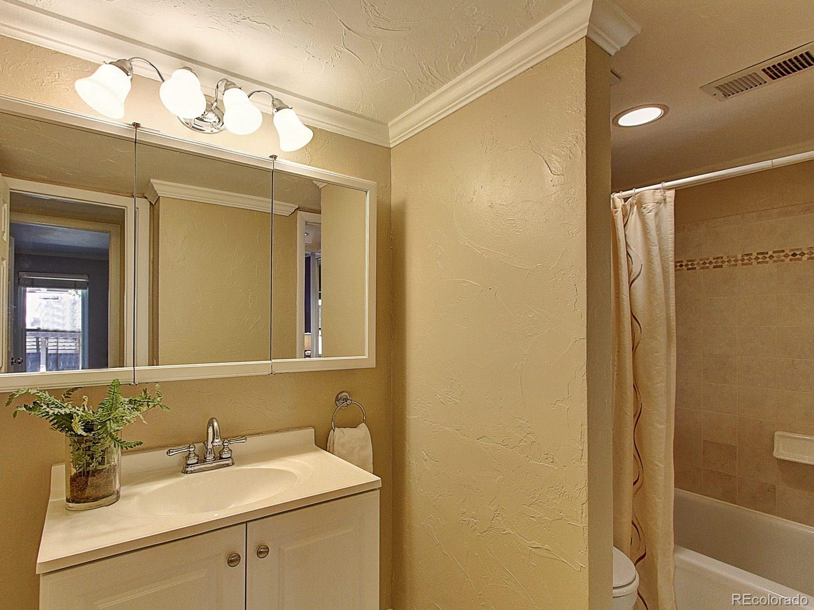 6410 South Dayton Street, Unit I08 Englewood, CO 80111 - Photo 20 of 32 a bathroom with a sink and a mirror