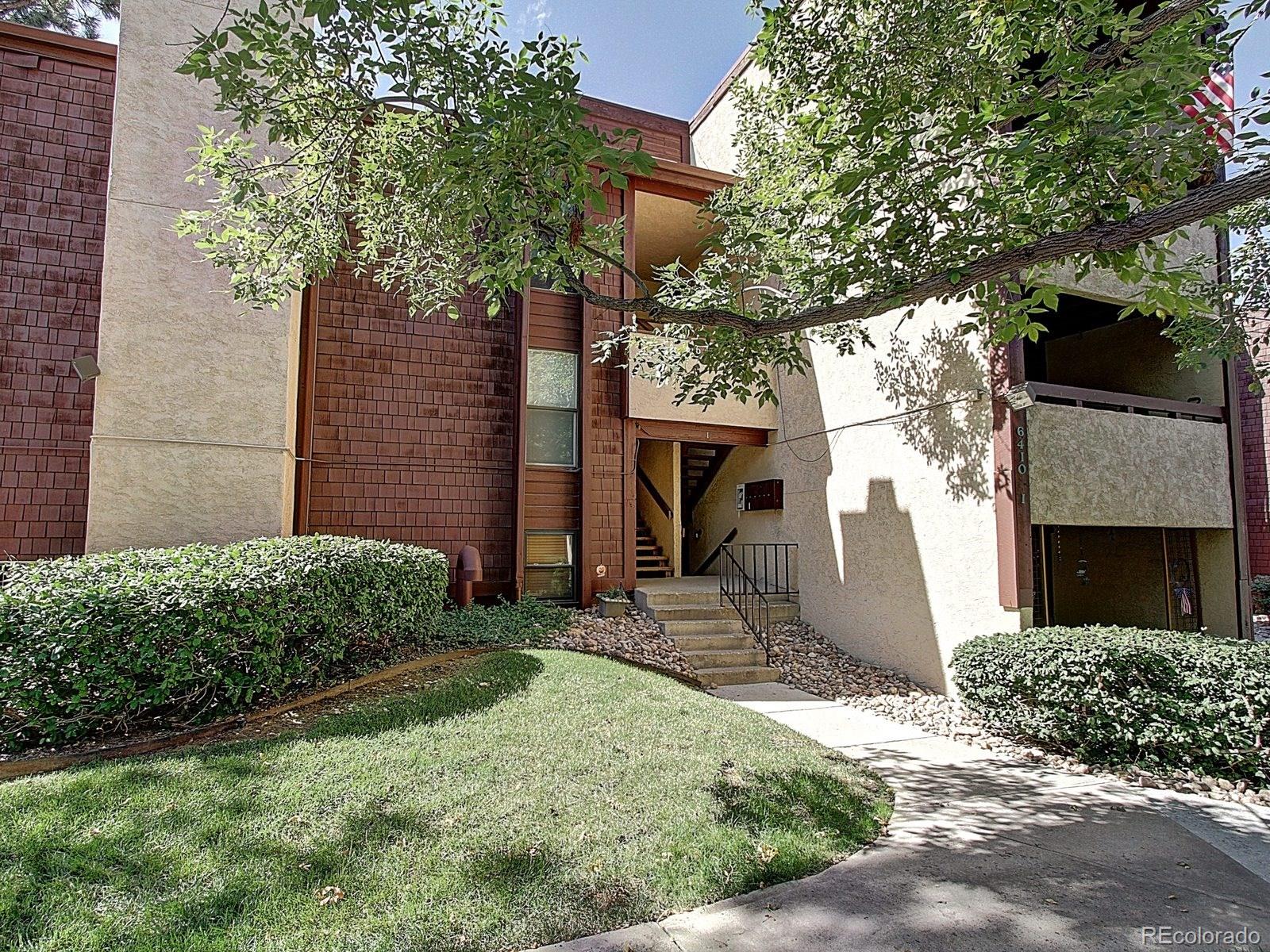 6410 South Dayton Street, Unit I08 Englewood, CO 80111 - Photo 2 of 32 a front view of a house with garden