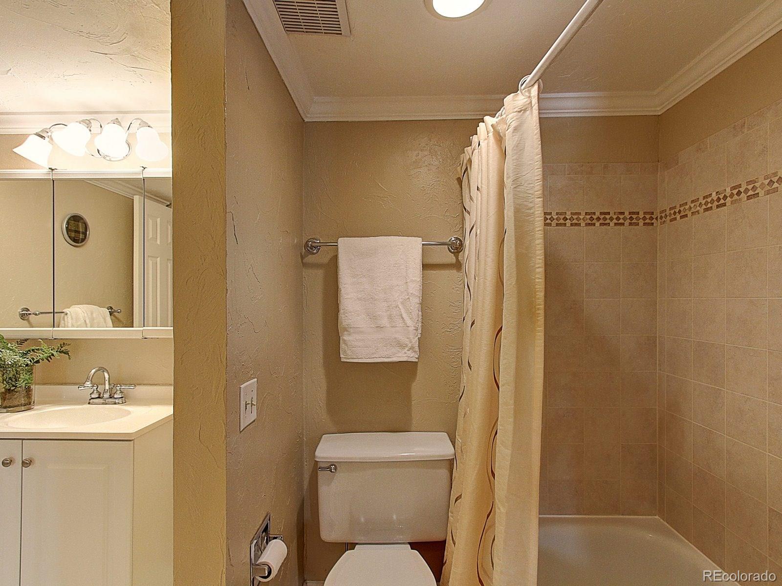 6410 South Dayton Street, Unit I08 Englewood, CO 80111 - Photo 21 of 32 a bathroom with a toilet sink vanity and shower