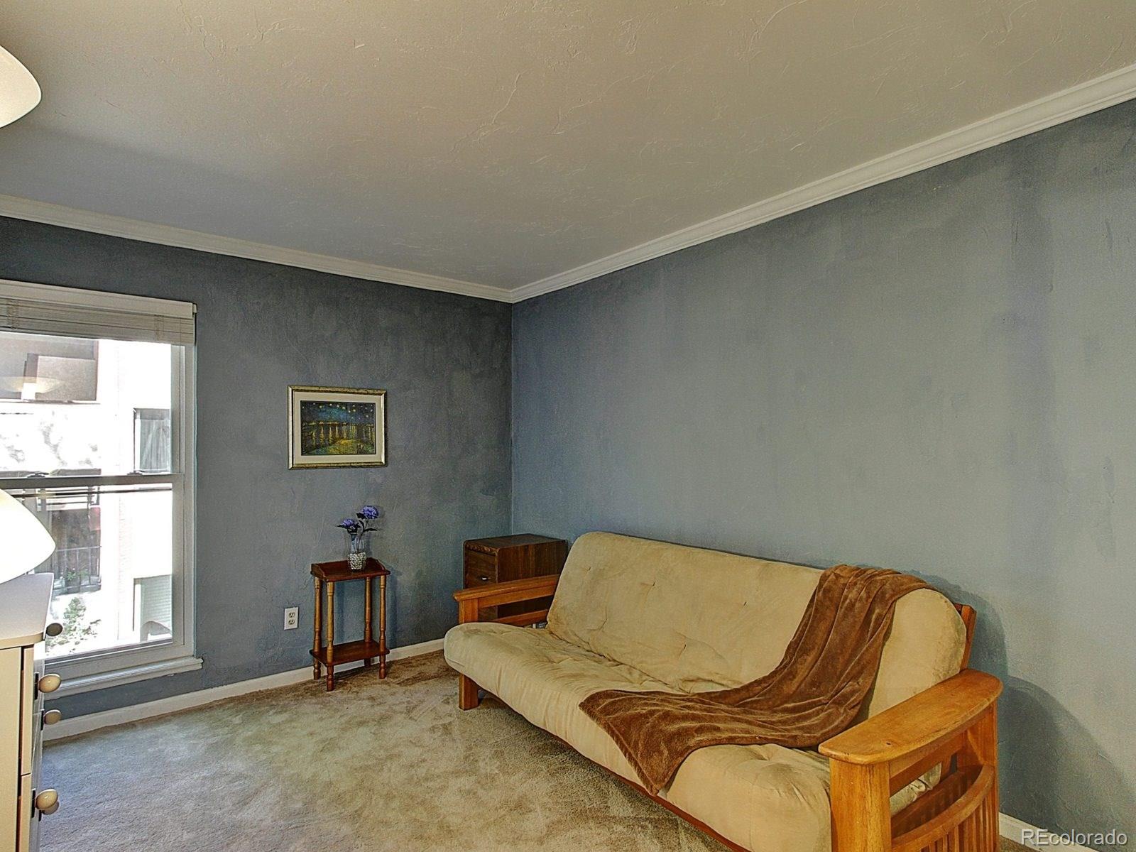 6410 South Dayton Street, Unit I08 Englewood, CO 80111 - Photo 23 of 32 a living room with a couch and a window