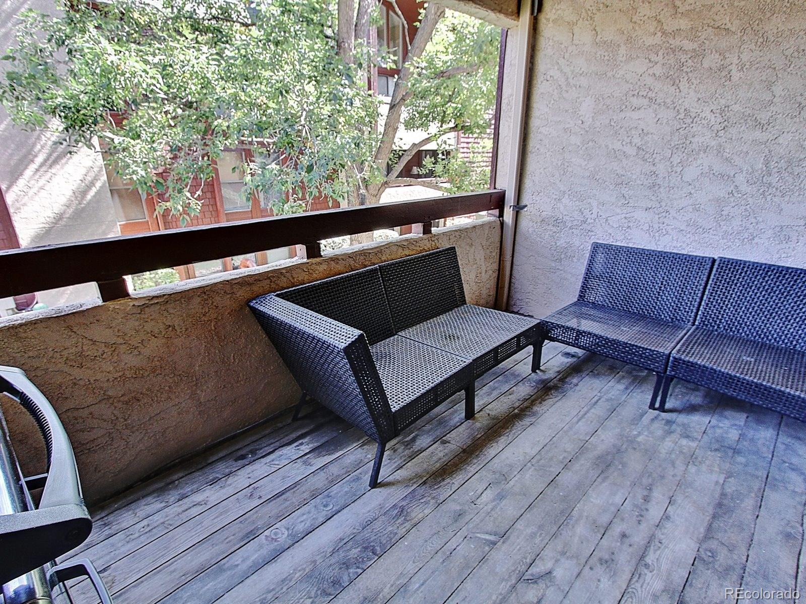 6410 South Dayton Street, Unit I08 Englewood, CO 80111 - Photo 25 of 32 a living room with furniture and a wooden floor