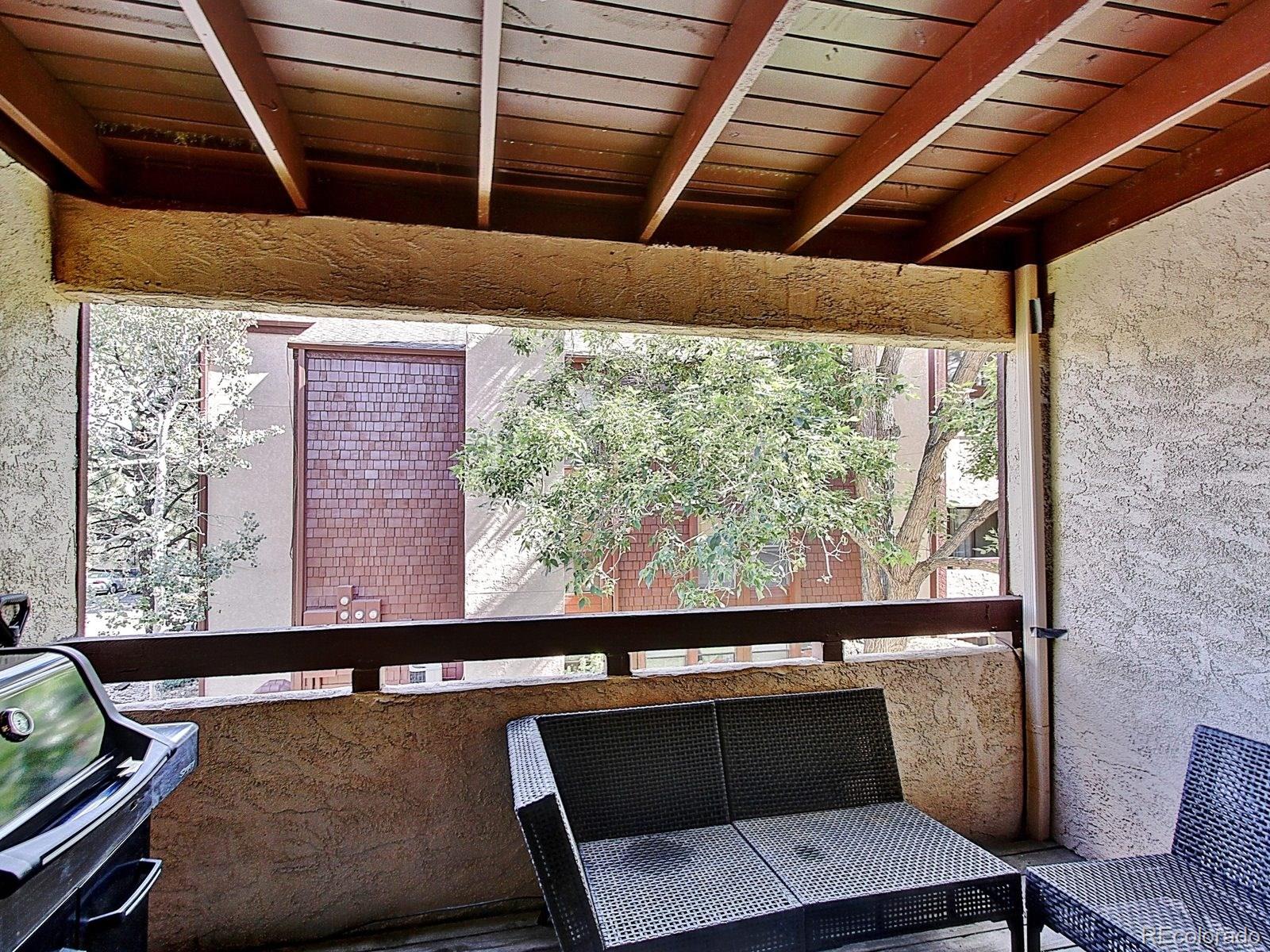 6410 South Dayton Street, Unit I08 Englewood, CO 80111 - Photo 26 of 32 a view of a chair and table in the balcony