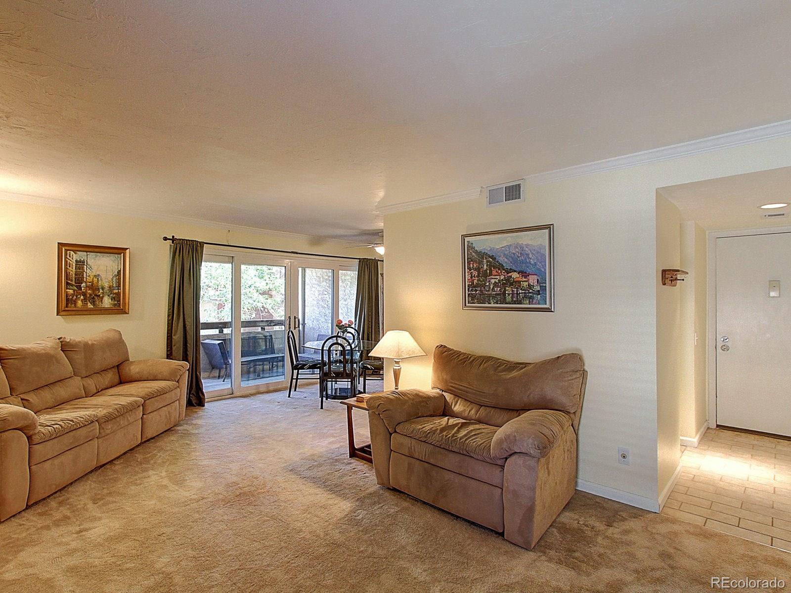6410 South Dayton Street, Unit I08 Englewood, CO 80111 - Photo 3 of 32 a living room with furniture and a large window