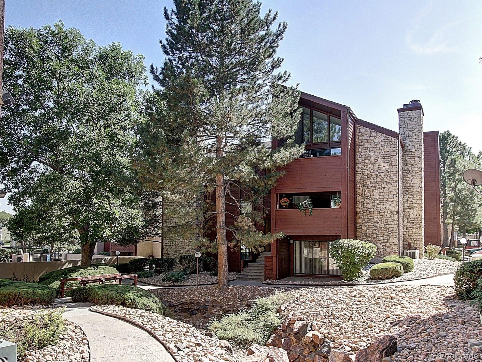 6410 South Dayton Street, Unit I08 Englewood, CO 80111 - Photo 32 of 32 a front view of a house with parking area