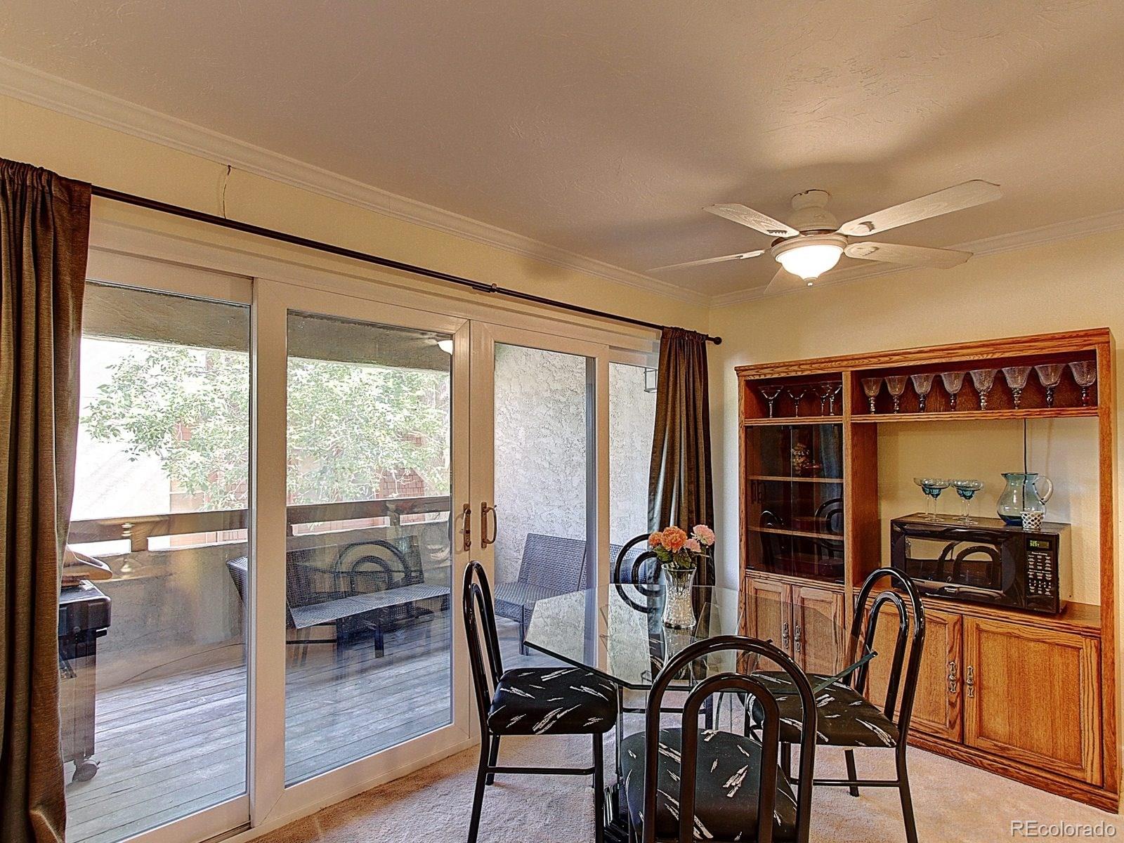 6410 South Dayton Street, Unit I08 Englewood, CO 80111 - Photo 7 of 32 a view of a dining room with furniture window and outside view