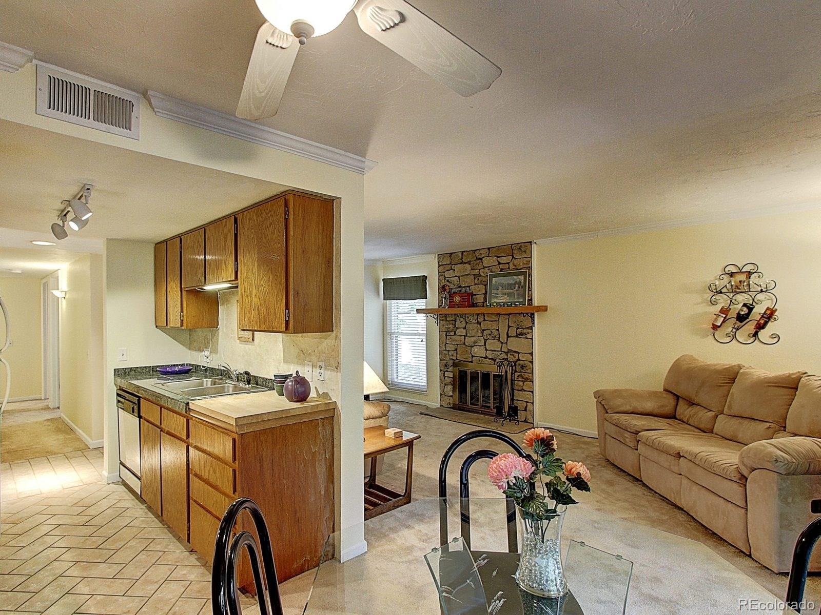 6410 South Dayton Street, Unit I08 Englewood, CO 80111 - Photo 8 of 32 a livingroom with furniture and a stove