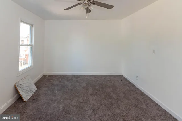 an empty room with windows and couch