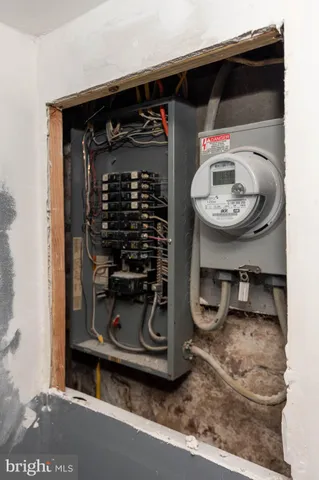 a close view of a sink storage and utility room with two washing machine