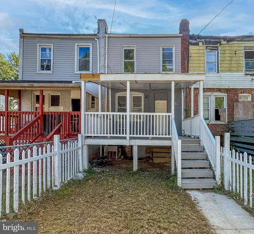 a view of a house with wooden deck and deck