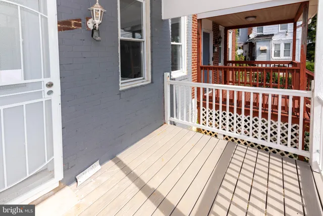 a view of a balcony with wooden floor