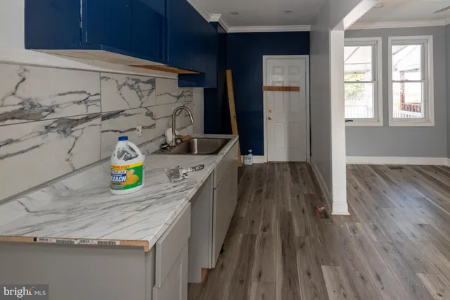 view of a kitchen with a wooden floor and more cabinets
