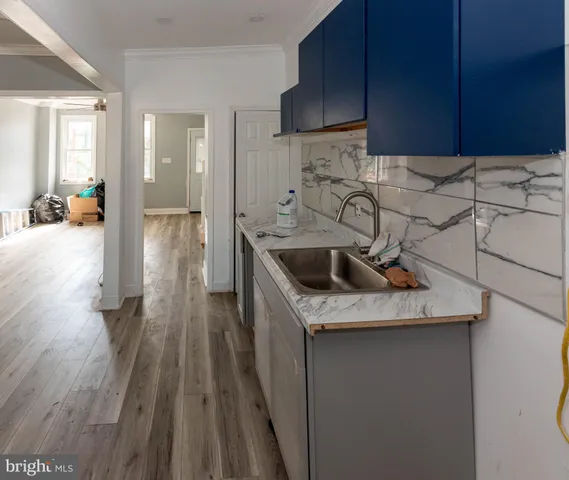 a kitchen with a sink a stove and cabinets