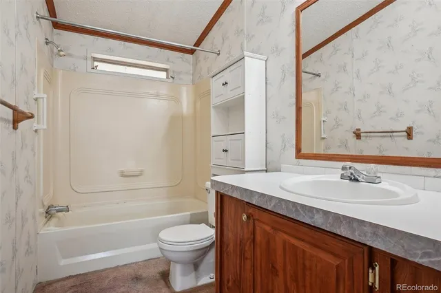 a view of a livingroom with glass door and a ceiling fan