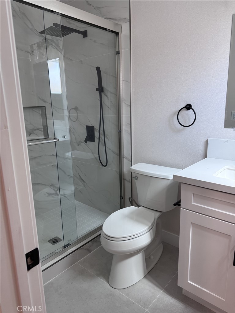 13431 Goldenwest Street Westminster, CA 92683 - Photo 21 of 23 a white toilet sitting next to a bathroom sink