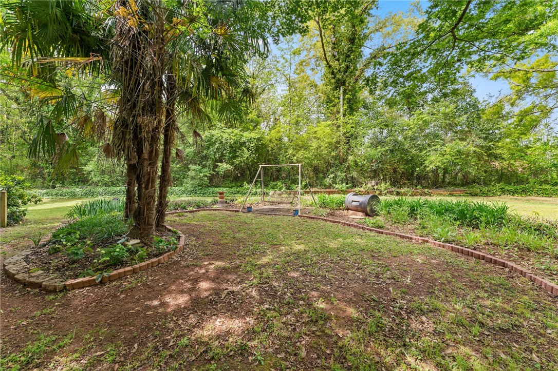 1412 Forest Lane Anderson, SC 29621 - Photo 13 of 31 This spacious backyard offers ample green space and natural surroundings.