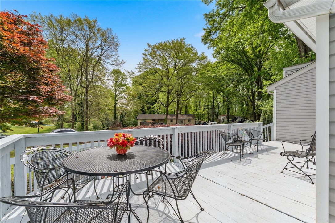 1412 Forest Lane Anderson, SC 29621 - Photo 14 of 31 Great outdoor deck offers a serene escape, perfect for gatherings surrounded by beautiful landscaping.