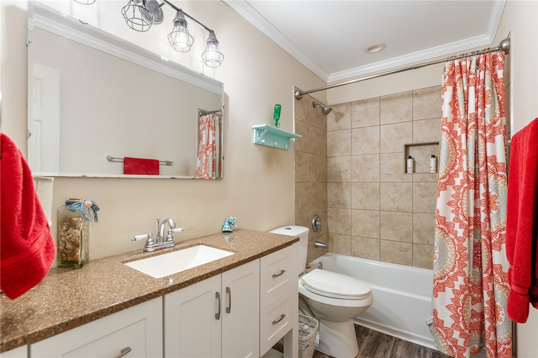 1412 Forest Lane Anderson, SC 29621 - Photo 19 of 31 This bathroom features a sleek vanity, tiled shower, and durable flooring for modern comfort.