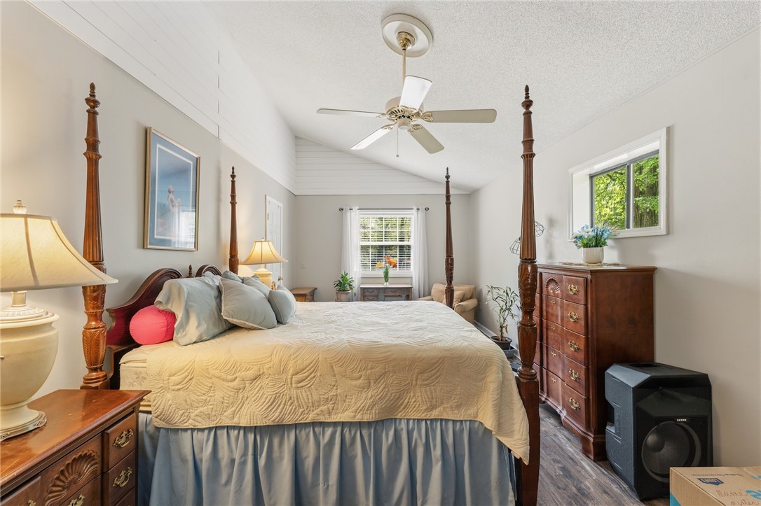 1412 Forest Lane Anderson, SC 29621 - Photo 23 of 31 This spacious bedroom offers high vaulted ceilings, creating an open and airy retreat.