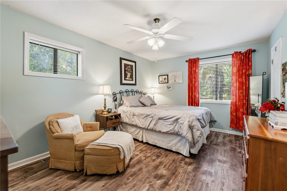 1412 Forest Lane Anderson, SC 29621 - Photo 28 of 31 This inviting bedroom features rich wood flooring, ample natural light, and a cooling ceiling fan.