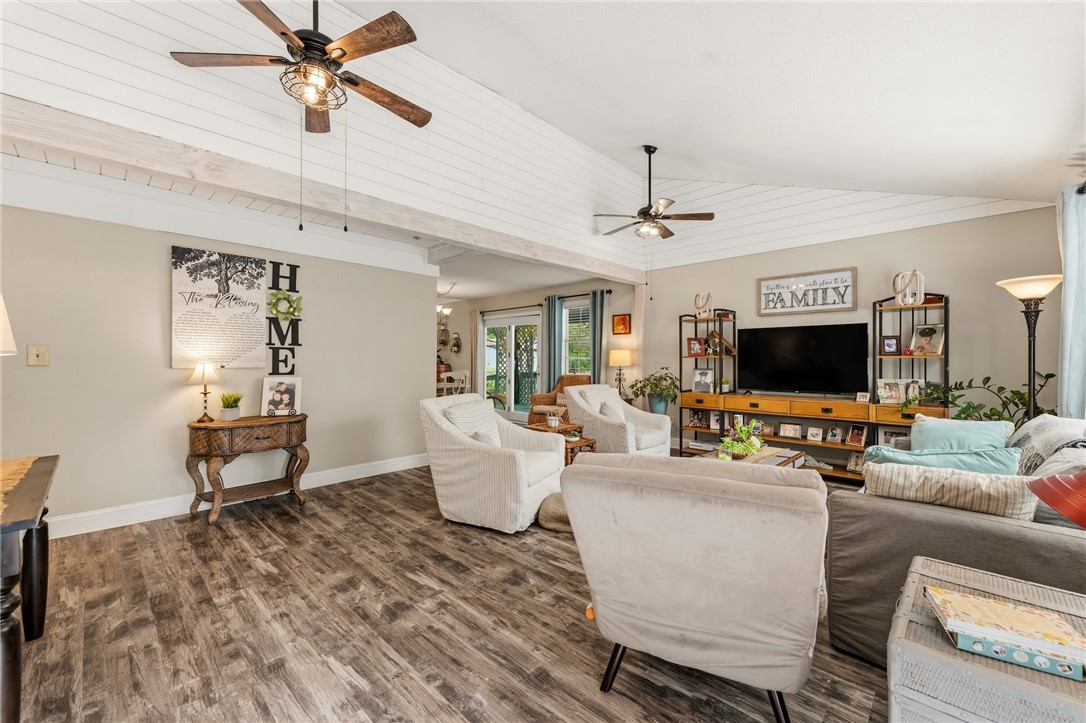 1412 Forest Lane Anderson, SC 29621 - Photo 8 of 31 The living room features vaulted ceilings and LVP flooring, creating an inviting and airy atmosphere.