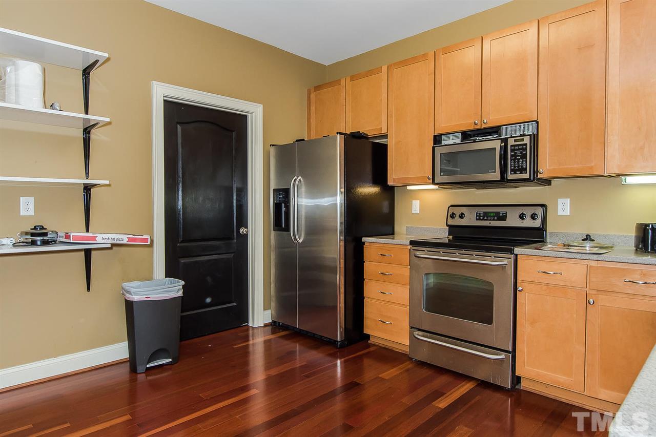 3811 Lunceston Way, Unit 301 Raleigh, NC 27613 - Photo 4 of 8 a kitchen with a refrigerator sink and microwave