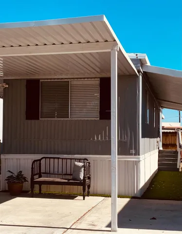 a view of a house with a door and wooden floor