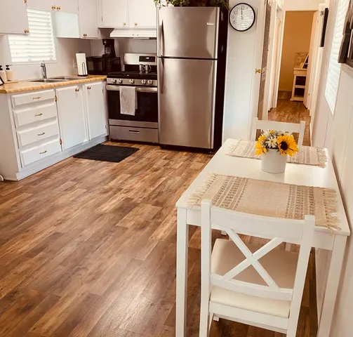 a kitchen with a refrigerator and a stove