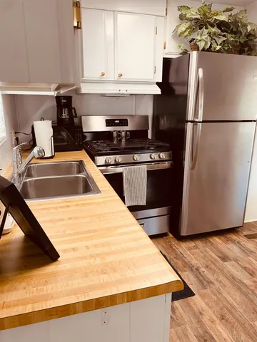 a bathroom with a granite countertop sink toilet and mirror