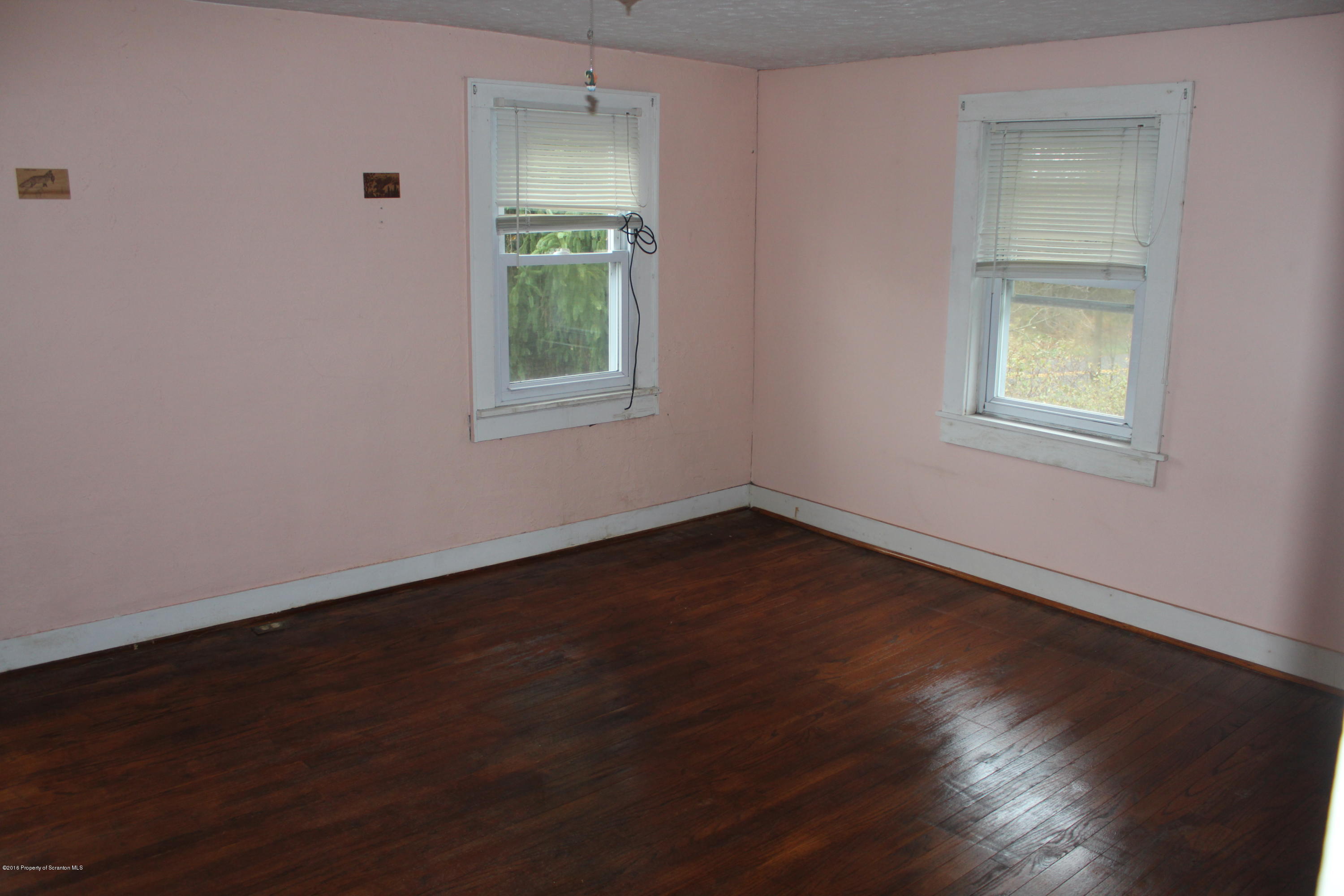 515 State Rte 2023 Forest City, PA 18421 - Photo 16 of 40 an empty room with wooden floor and windows