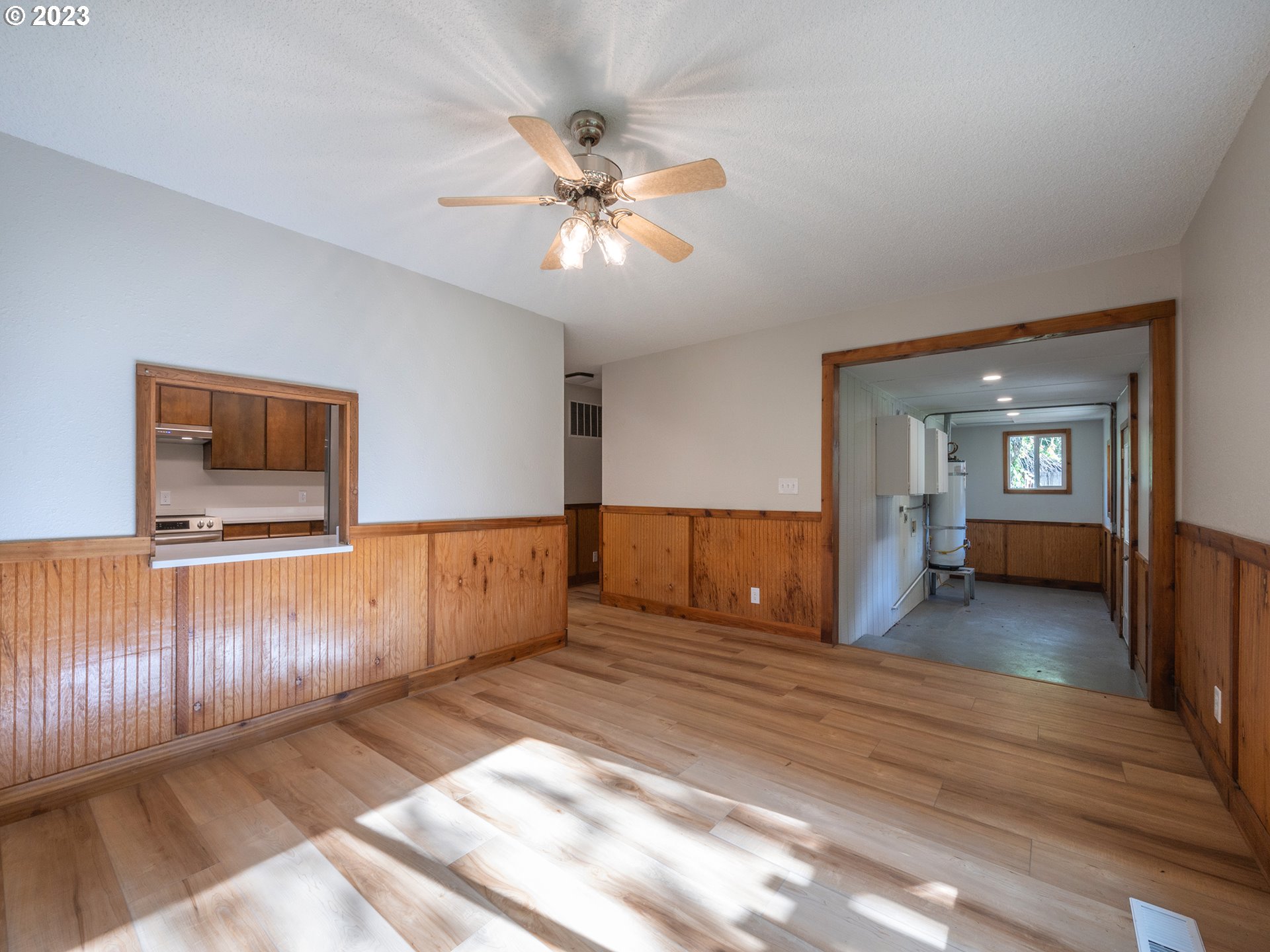 1590 Romie Howard Road Yoncalla, OR 97499 - Photo 14 of 48 a view of a livingroom with wooden floor and a ceiling fan