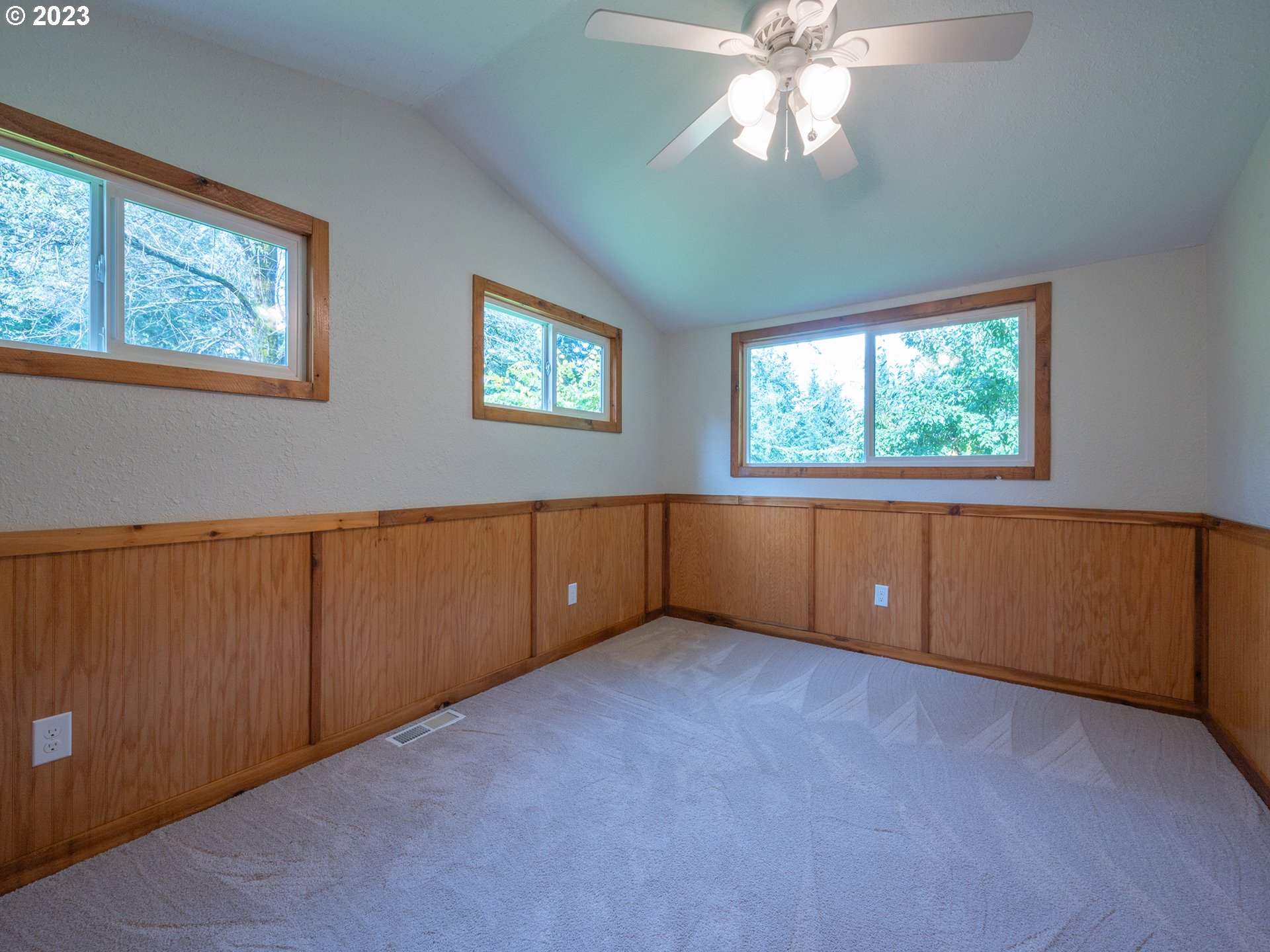 1590 Romie Howard Road Yoncalla, OR 97499 - Photo 20 of 48 an empty room with windows and chandelier fan