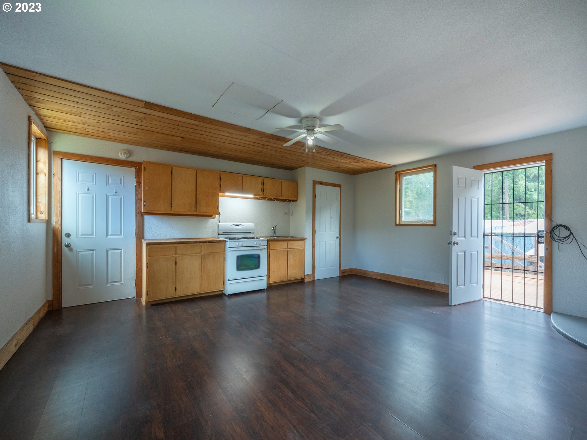 1590 Romie Howard Road Yoncalla, OR 97499 - Photo 26 of 48 an empty room with wooden floor and windows
