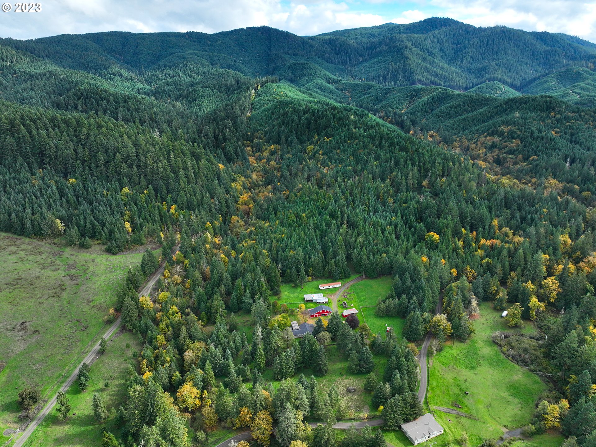 1590 Romie Howard Road Yoncalla, OR 97499 - Photo 4 of 48 a view of a lush green hillside and a building