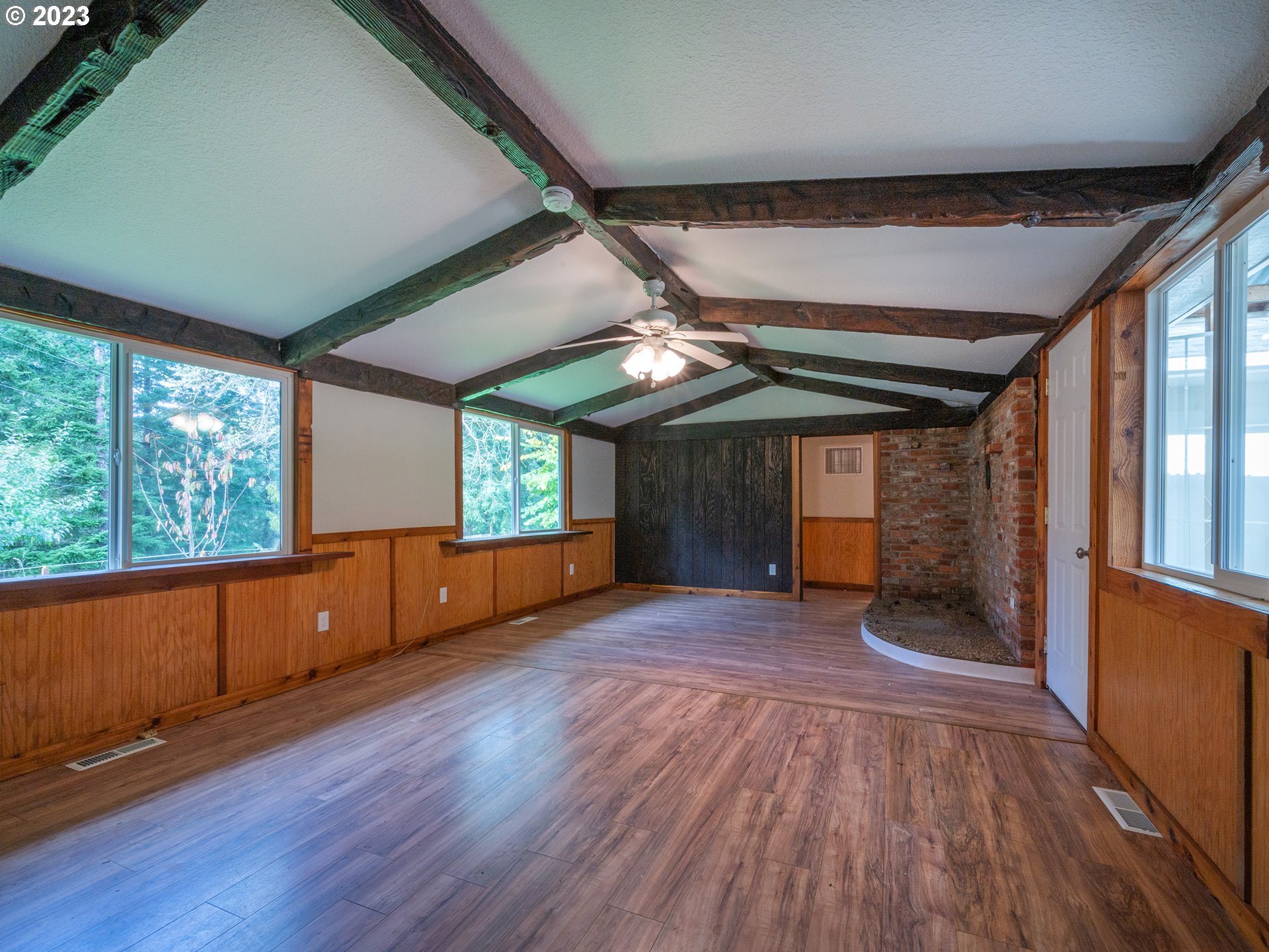 1590 Romie Howard Road Yoncalla, OR 97499 - Photo 7 of 48 an empty room with wooden floor and windows