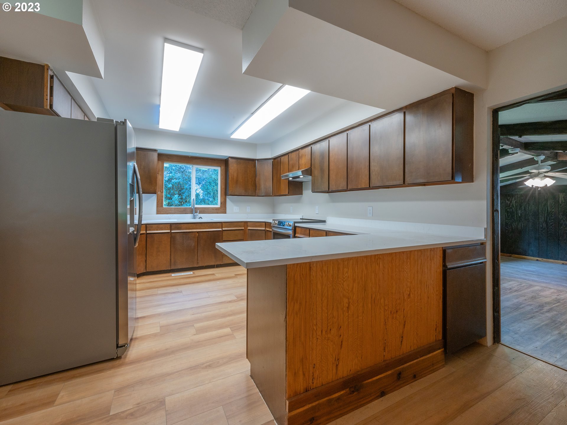 1590 Romie Howard Road Yoncalla, OR 97499 - Photo 10 of 48 a kitchen with stainless steel appliances granite countertop a sink a stove a refrigerator cabinets and wooden floor