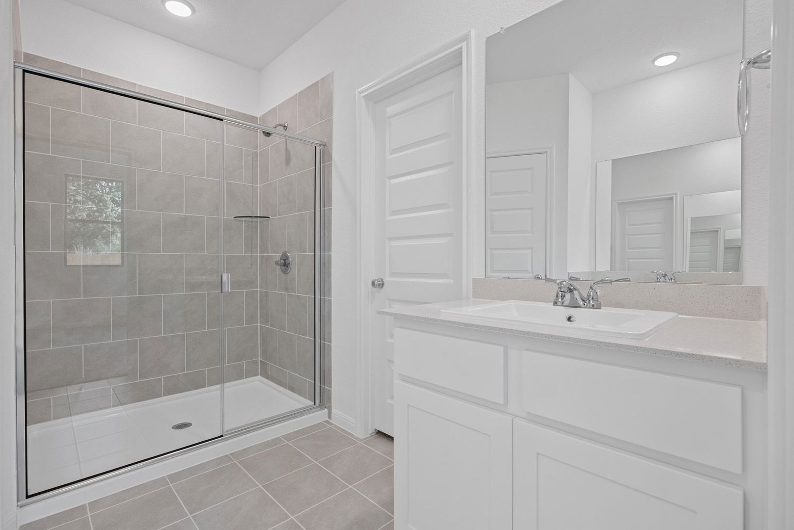 310 Bendecido Loop Elgin, TX 78621 - Photo 14 of 40 a bathroom with a shower and a sink