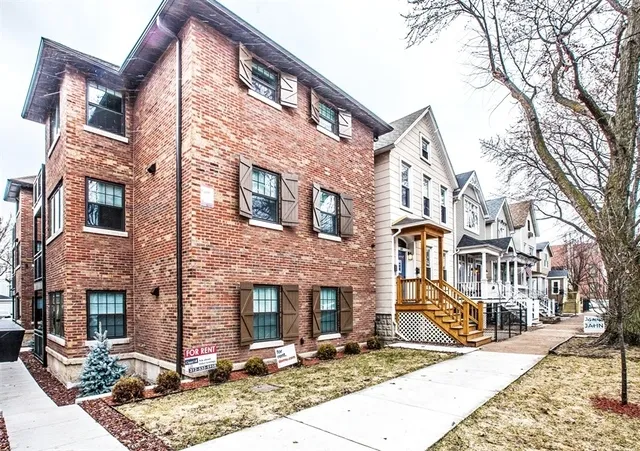 a front view of a building with brick walls