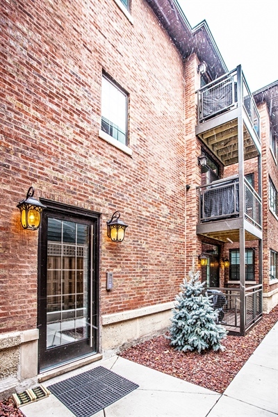 2141 West Fletcher Street, Unit 3F Chicago, IL 60618 - Photo 2 of 11 a front view of a house with a garden
