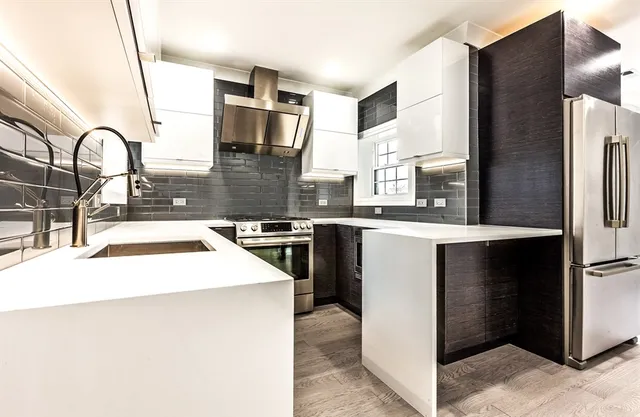 a kitchen with a sink a stove and refrigerator