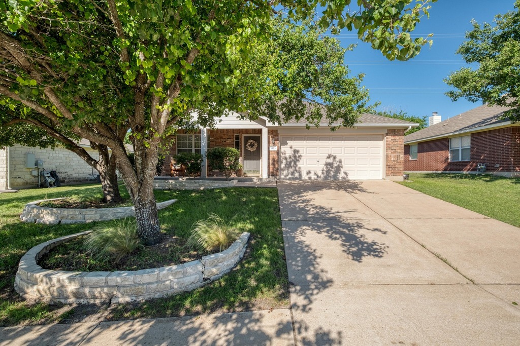 1303 Ridgewood Drive Leander, TX 78641 - Photo 2 of 28 a front view of a house with garden