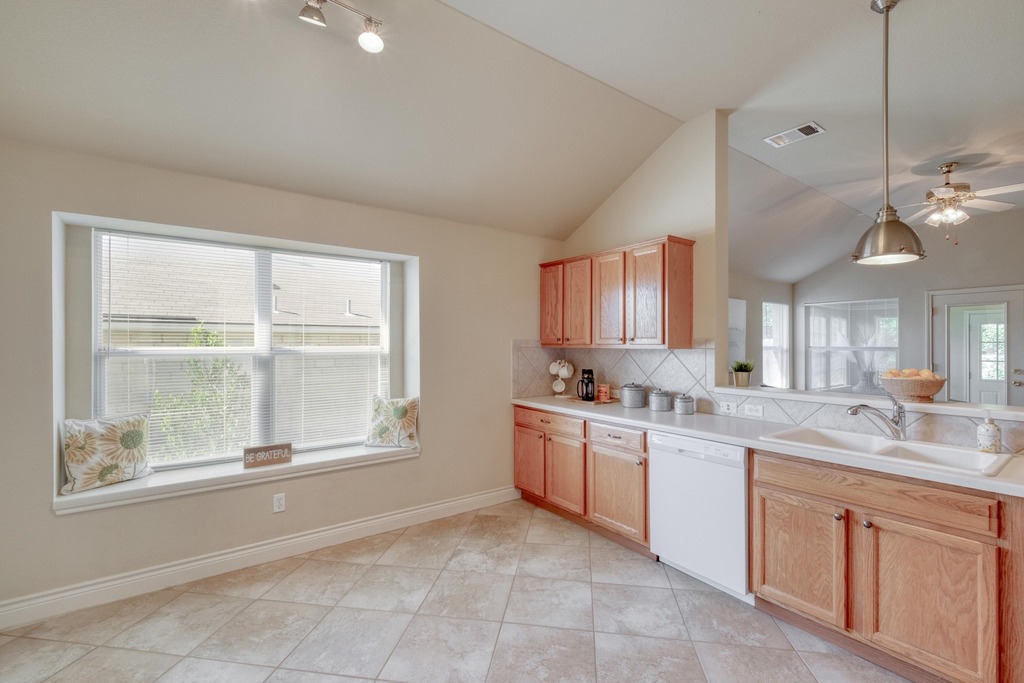 1303 Ridgewood Drive Leander, TX 78641 - Photo 7 of 28 a large kitchen with kitchen island a large window in it