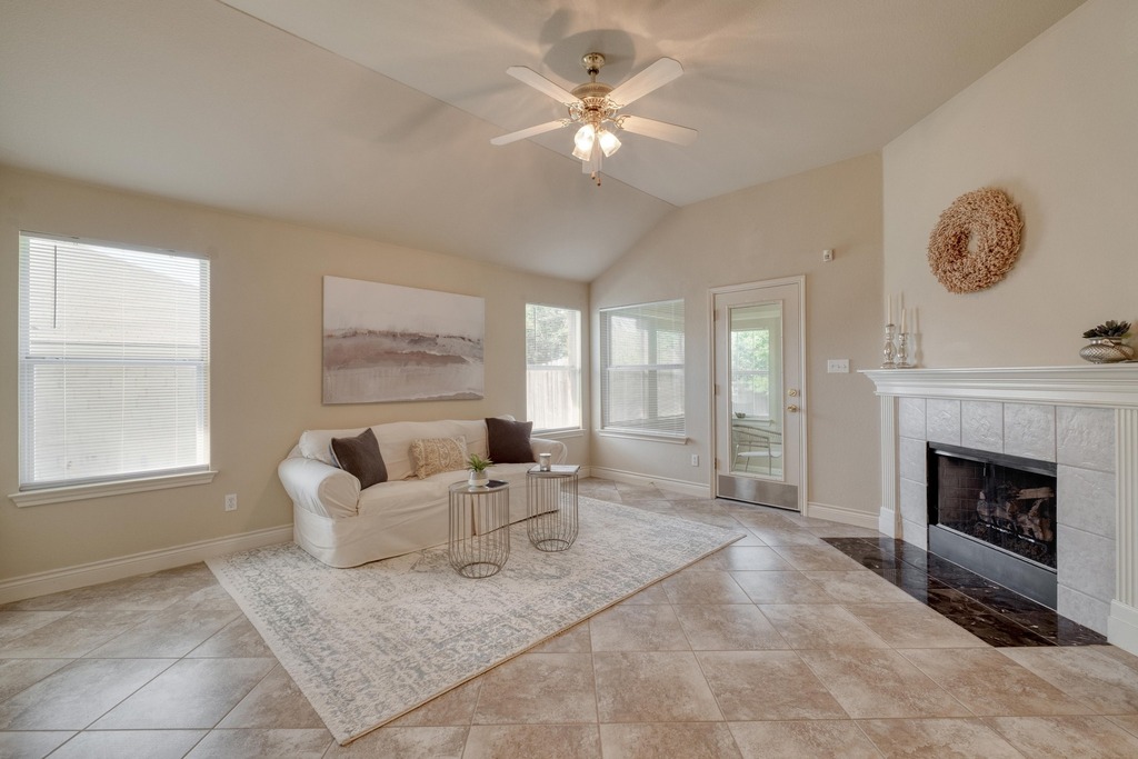 1303 Ridgewood Drive Leander, TX 78641 - Photo 9 of 28 a living room with furniture and a fireplace