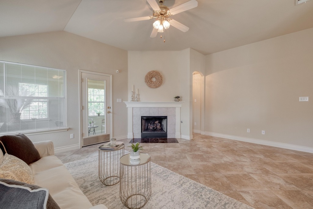 1303 Ridgewood Drive Leander, TX 78641 - Photo 10 of 28 a living room with furniture a fireplace and a large window