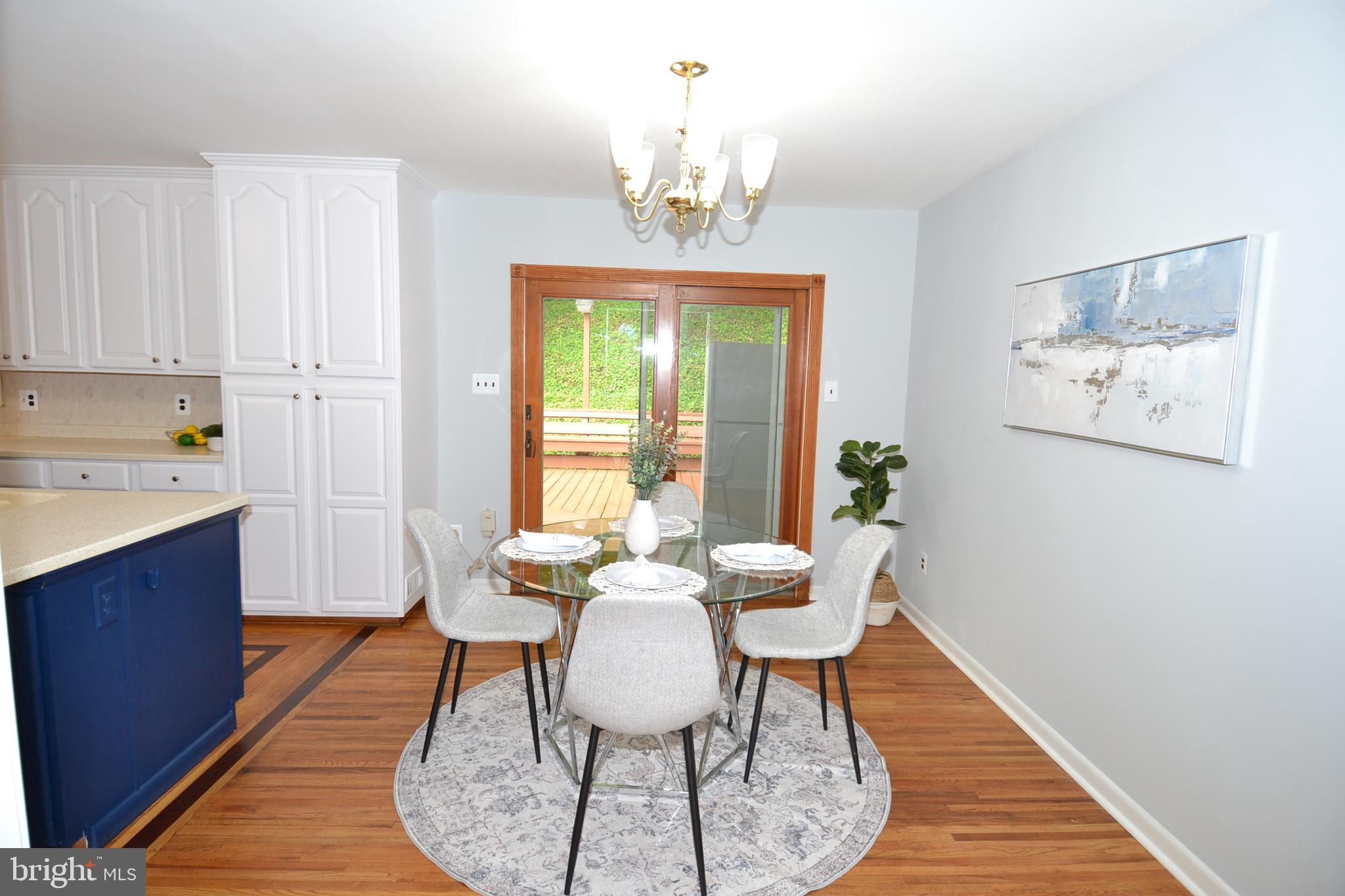 7103 Galgate Drive Springfield, VA 22152 - Photo 15 of 47 a view of a dining room with furniture window and wooden floor
