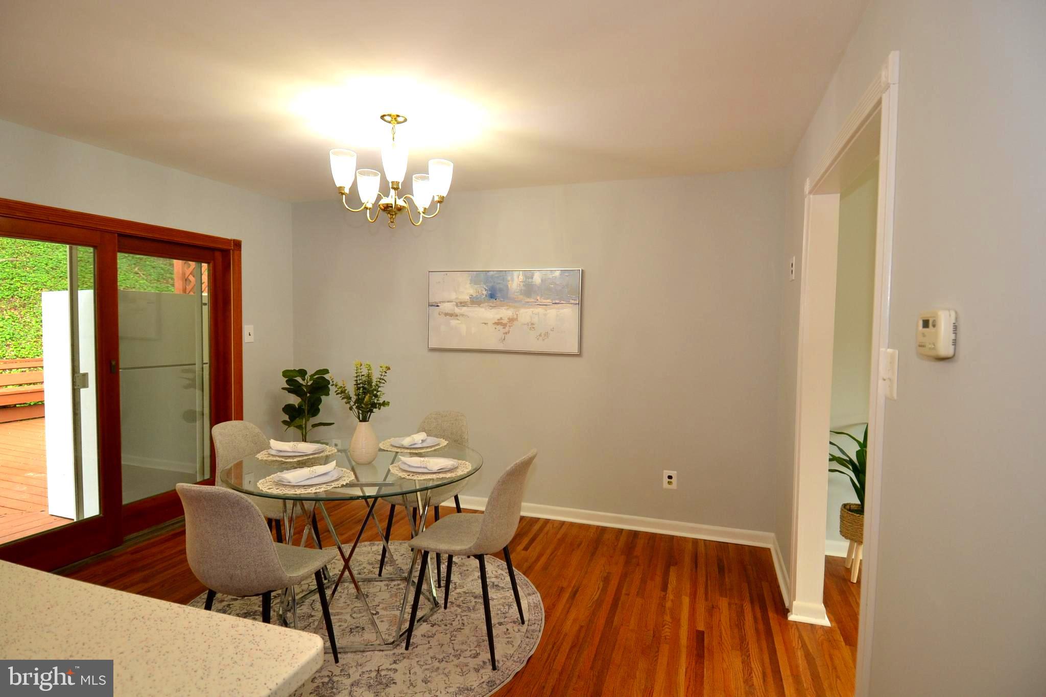 7103 Galgate Drive Springfield, VA 22152 - Photo 16 of 47 a view of a dining room with furniture window and outside view