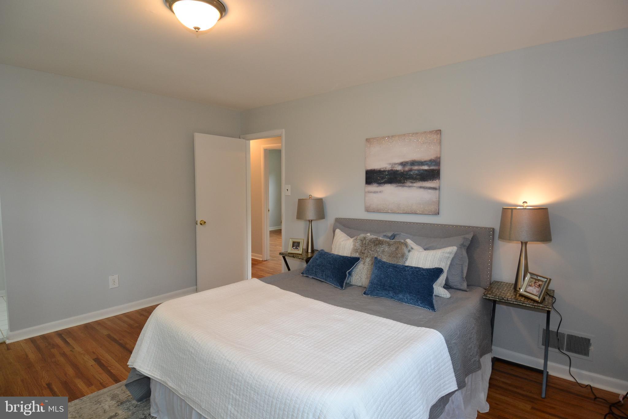 7103 Galgate Drive Springfield, VA 22152 - Photo 17 of 47 a bedroom with a bed and a lamp