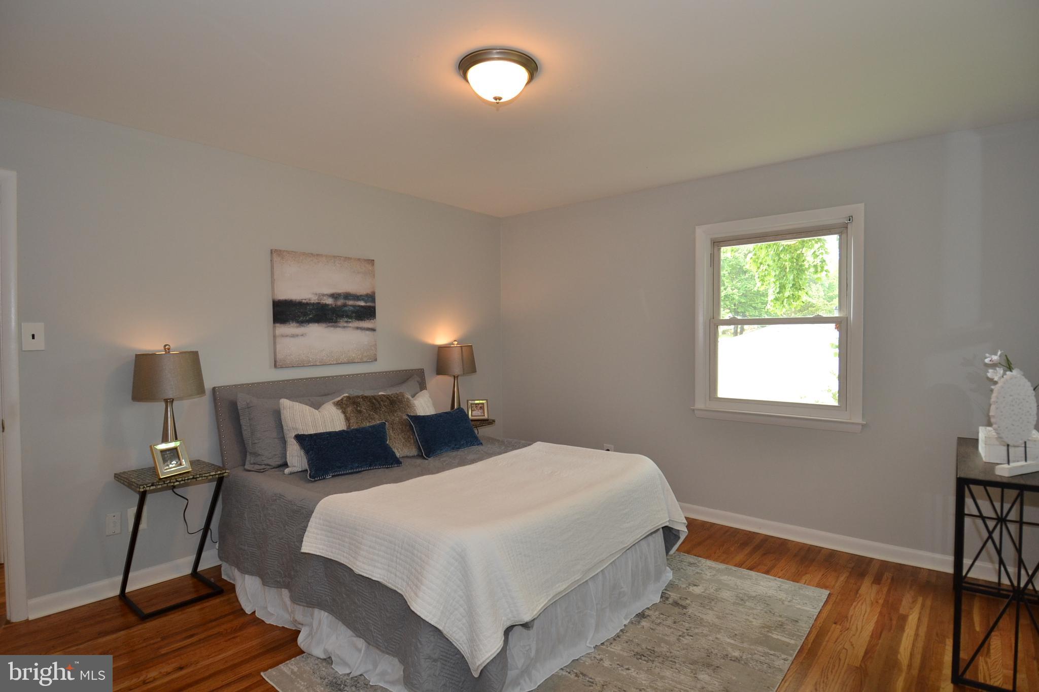 7103 Galgate Drive Springfield, VA 22152 - Photo 18 of 47 a bedroom with a bed and a table