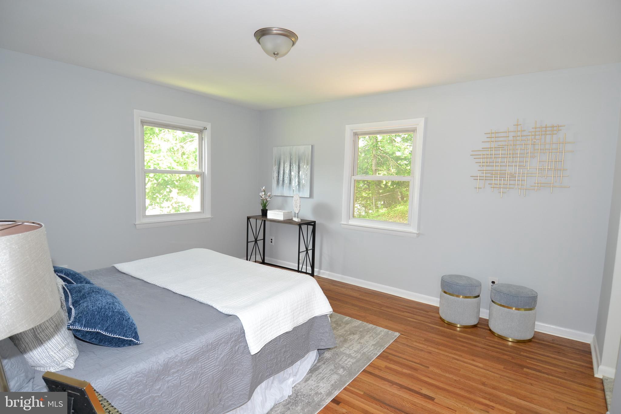 7103 Galgate Drive Springfield, VA 22152 - Photo 20 of 47 a spacious bedroom with a bed and wooden floor