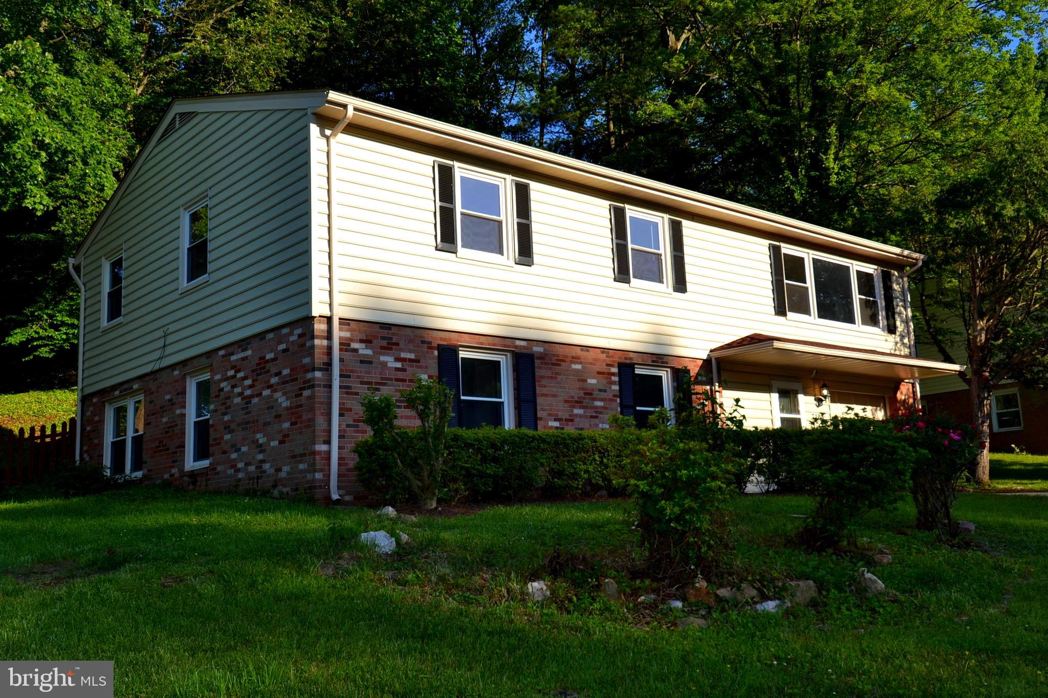 7103 Galgate Drive Springfield, VA 22152 - Photo 2 of 47 a front view of a house with a garden