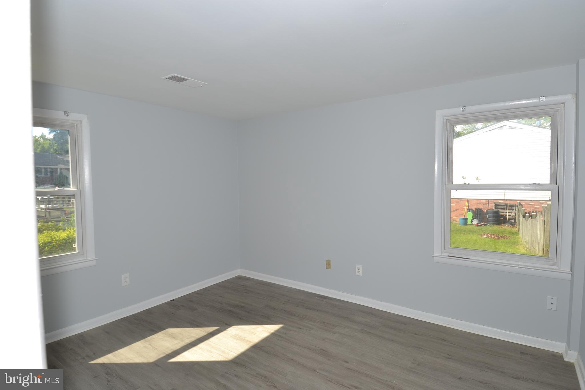 7103 Galgate Drive Springfield, VA 22152 - Photo 22 of 47 an empty room with wooden floor and windows